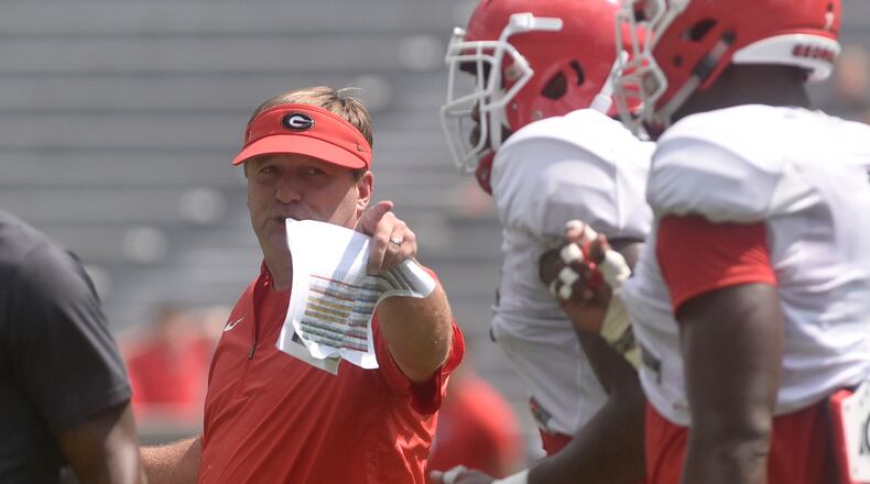 UGA coach Kirby Smart talks to a group of Bulldogs during the annual fan day at Sanford Stadium on Saturday.