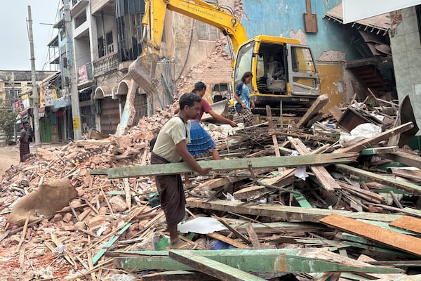 People clean debris from damaged buildings in the aftermath of an earthquake on March 28, in Naypyitaw, Myanmar, Monday, April 7, 2025. (AP Photo)