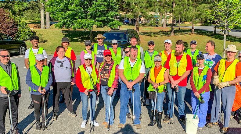 Event organizers briefed volunteers with roadside safety instructions and handed out orange safety vests and cleanup kits prior to the cleanup on Saturday, May 1. CONTRIBUTED