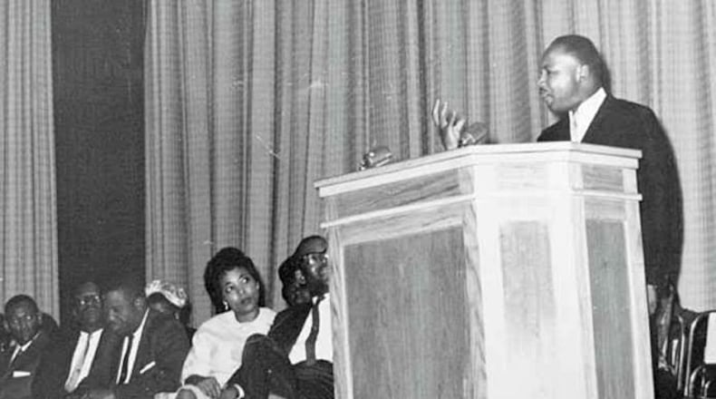 Dorothy Cotton as a young woman listens to a speech by Martin Luther King Jr.