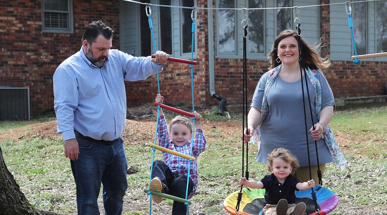 Melanie and Kris Lambert and their sons Connor, 5, and Harrison, 2, spend some family time in their backyard while preparing for the birth of their third son. Melanie says that worrying about COVID-19 became a part of her pregnancy. “I am a mask wearer and use hand sanitizer and we do things we need to do, but I just went into hyperdrive,” she said. (Curtis Compton / Curtis.Compton@ajc.com)