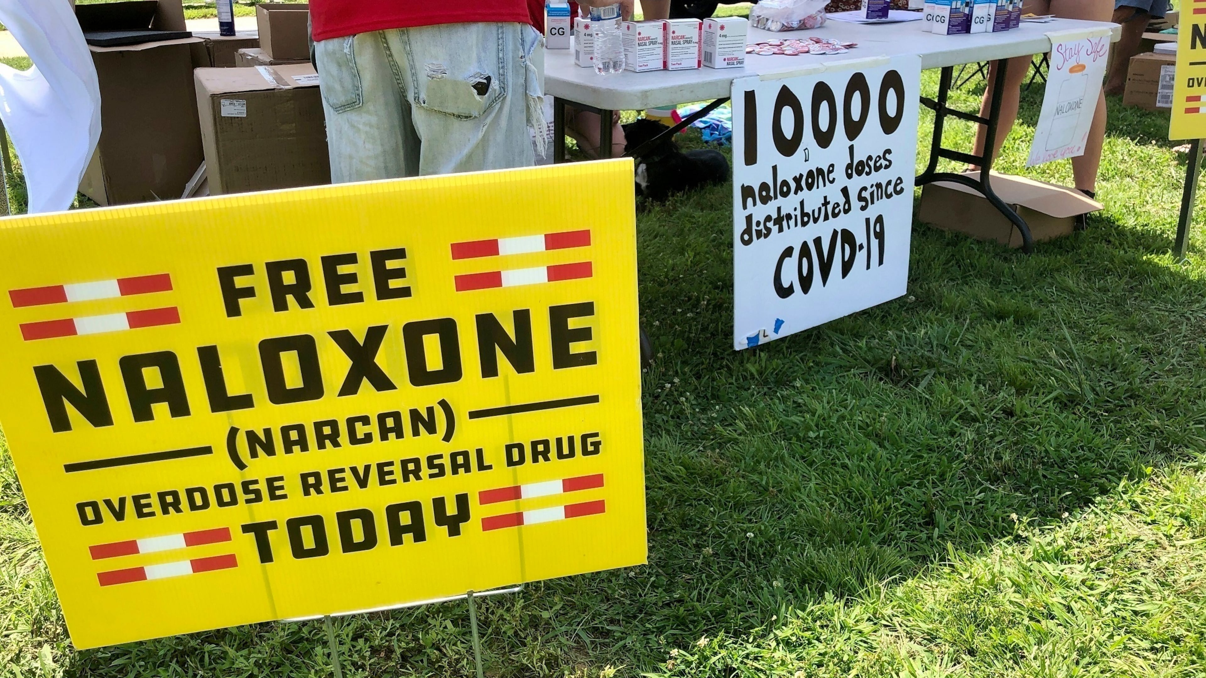 FILE - Signs are displayed at a tent during a health event June 26, 2021, in Charleston, W.Va. (AP Photo/John Raby, File)