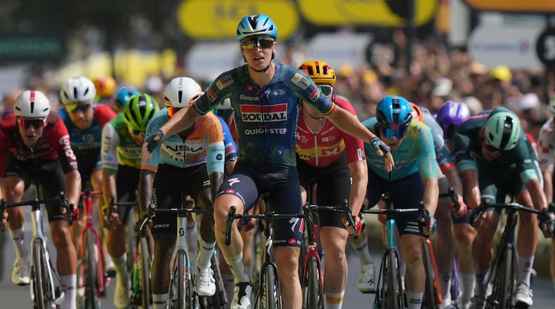Belgium's Tim Merlier celebrates as he crosses the finish line to win the seventh stage of the Tour de France cycling race with start in Hagetmau and finish in Bordeaux, France, Friday, July 10, 2026. (AP Photo/Thibault Camus)