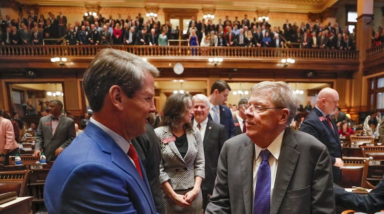 Georgia Gov. Brian Kemp (left) shakes hands with former U.S. Sen. Johnny Isakson after the governor’s State of the State address on Jan. 16, 2020. Kemp announced in his speech that the University of Georgia will create a professorship to research Parkinson’s disease. Isakson retired last year from the Senate after announcing he has the disease.   Bob Andres / bandres@ajc.com