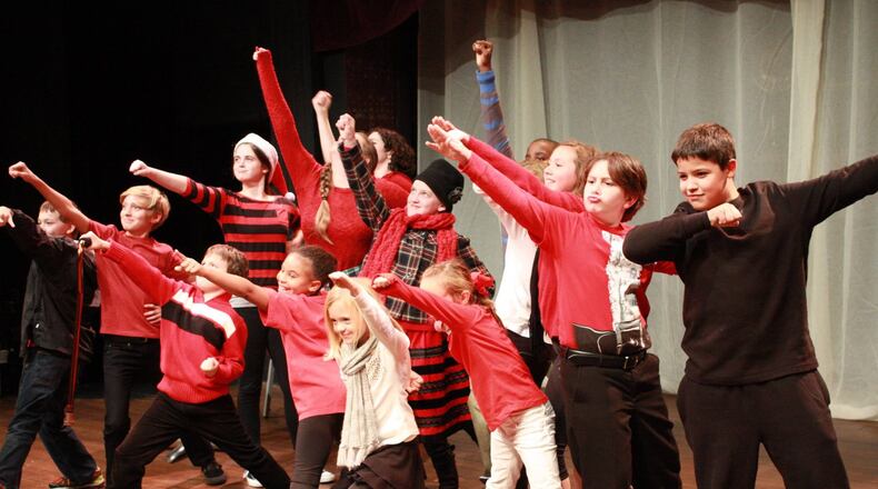 Schoolchildren on the stage at Aurora Theatre. The theatre is asking supporters to wear red to the Lawrenceville city council meeting Jan. 7 in support of the Lawrenceville Performing Arts Center Campus Expansion. Courtesy Aurora Theatre