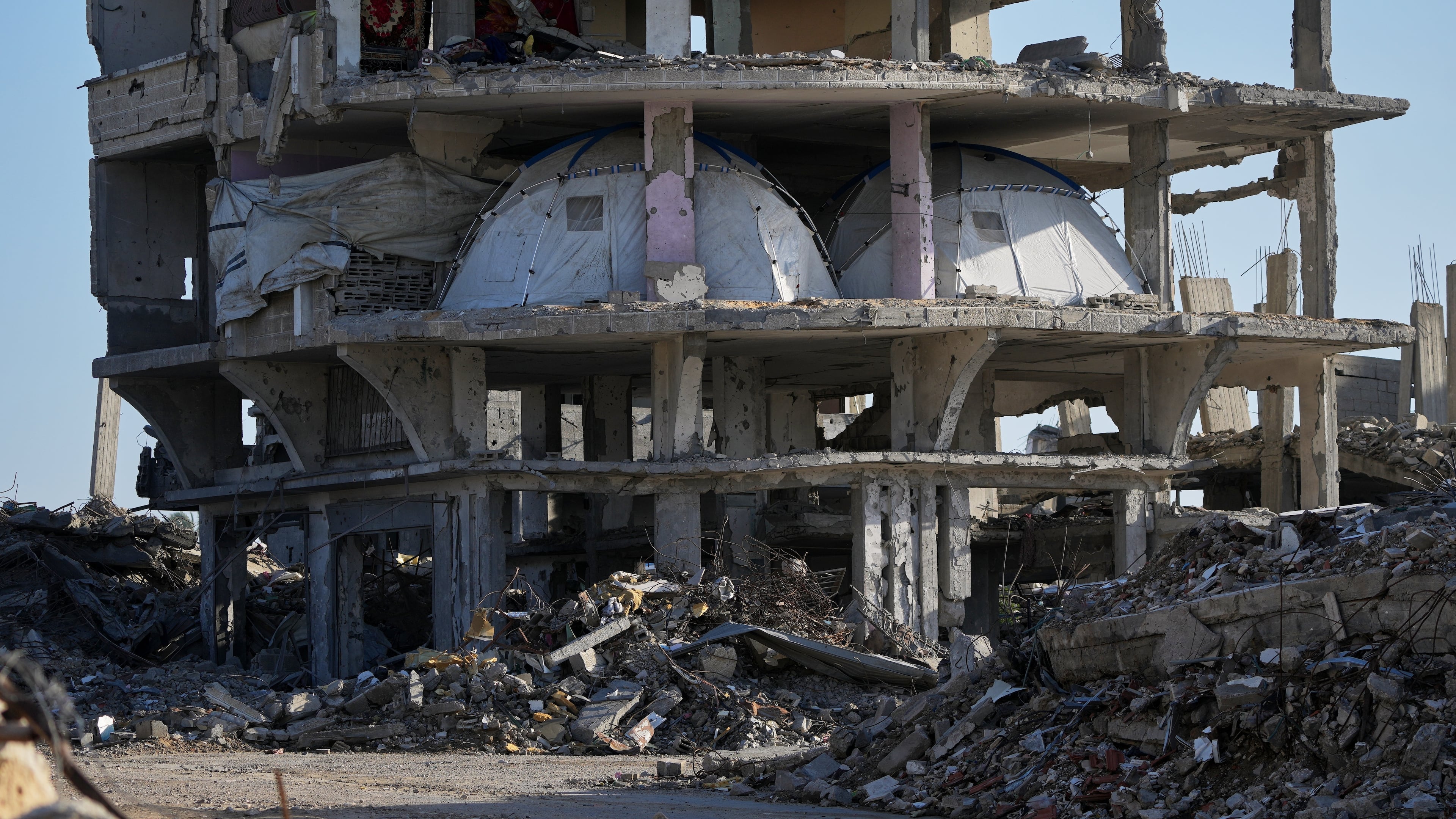 Tents are set up inside a gutted apartment building in Khan Younis, in the southern Gaza Strip, Saturday, Nov. 15, 2025. (AP Photo/Abdel Kareem Hana)