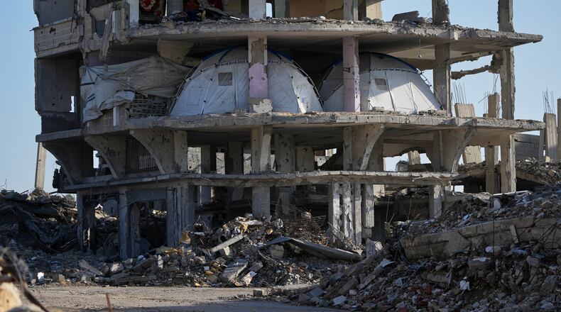 Tents are set up inside a gutted apartment building in Khan Younis, in the southern Gaza Strip, Saturday, Nov. 15, 2025. (AP Photo/Abdel Kareem Hana)