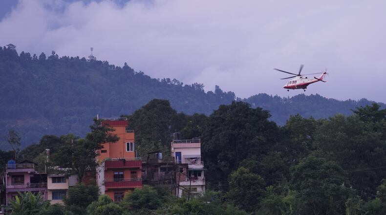 A government helicopter conducts a rescue mission amidst the devastation left by flash flooding in Nepal's Nuwakot district, Thursday, Aug. 27, 2026. (AP Photo/Rajesh Kumar Singh)