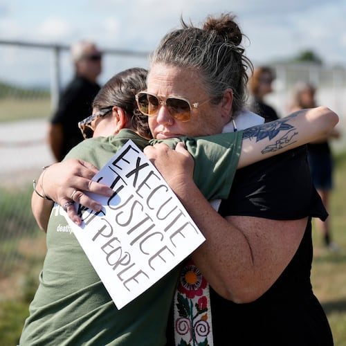 FILE - India Pungarcher, left, hugs Rev. Ingrid McIntyre as demonstrators gather in the area reserved for anti-death penalty protesters outside Riverbend Maximum Security Institution before the execution of Byron Black in Nashville, Tenn., on Tuesday, Aug. 5, 2025. (AP Photo/Mark Humphrey, File)