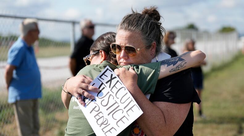 FILE - India Pungarcher, left, hugs Rev. Ingrid McIntyre as demonstrators gather in the area reserved for anti-death penalty protesters outside Riverbend Maximum Security Institution before the execution of Byron Black in Nashville, Tenn., on Tuesday, Aug. 5, 2025. (AP Photo/Mark Humphrey, File)