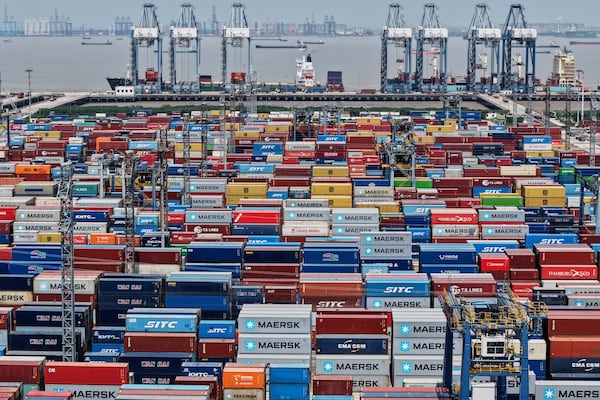 Containers are pile up at a container terminal in Shanghai, China, Sunday, April 20, 2025. (Chinatopix Via AP)