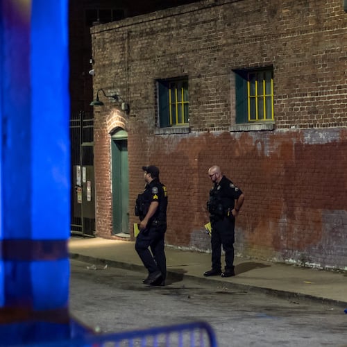 Atlanta police investigators work the scene of a fatal shooting in September 2024 at a parking lot near Edgewood Avenue and Hilliard Street in the Sweet Auburn neighborhood of Atlanta. Edgewood Avenue is a popular nightlife strip nestled in the middle of the Rev. Martin Luther King Jr.’s home neighborhood. (John Spink/AJC)