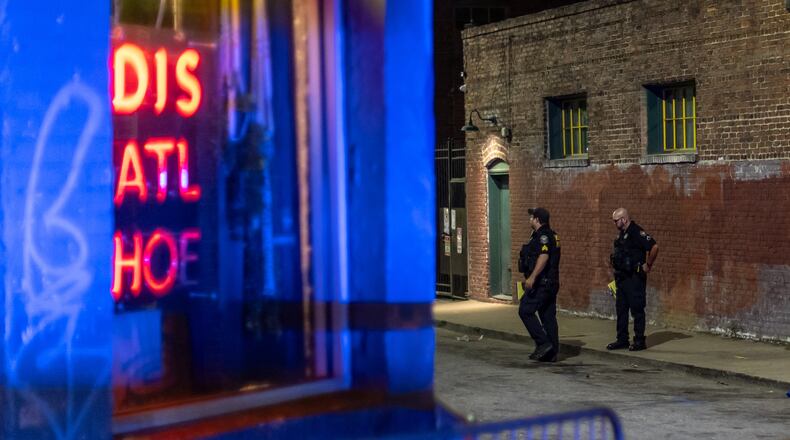 Atlanta police investigators work the scene of a fatal shooting in September 2024 at a parking lot near Edgewood Avenue and Hilliard Street in the Sweet Auburn neighborhood of Atlanta. Edgewood Avenue is a popular nightlife strip nestled in the middle of the Rev. Martin Luther King Jr.’s home neighborhood. (John Spink/AJC)
