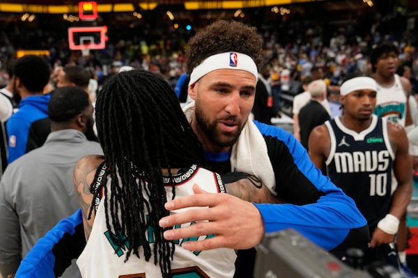 Dallas Mavericks guard Klay Thompson, right, hugs Memphis Grizzlies guard Ja Morant after an NBA play-in tournament basketball game Friday, April 18, 2025, in Memphis, Tenn. (AP Photo/George Walker IV)