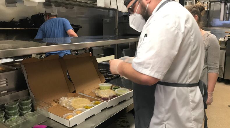 Coalition Food and Beverage executive chef Dean Hill fills orders for family-style Taco Tuesday at sister restaurant Osteria Mattone. LIGAYA FIGUERAS/LIGAYA.FIGUERAS@AJC.COM