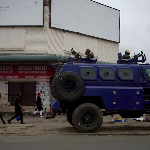A police vehicle is parked on a sidewalk, on the outskirts of Lusaka, Zambia, Friday, Aug. 14, 2026. (AP Photo/Alfonso Nqunjana)