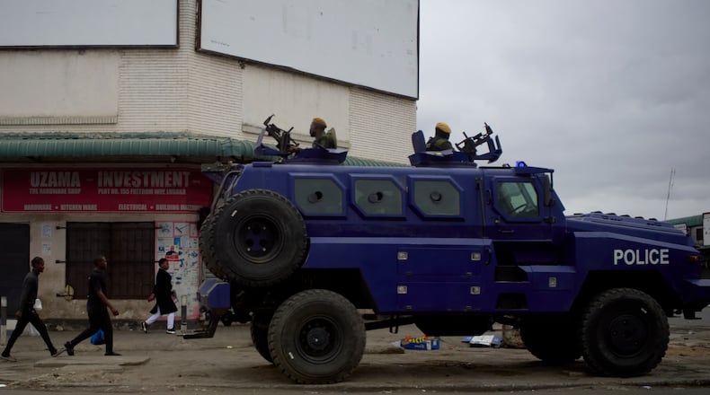 A police vehicle is parked on a sidewalk, on the outskirts of Lusaka, Zambia, Friday, Aug. 14, 2026. (AP Photo/Alfonso Nqunjana)