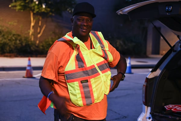 Larry McCrary arrives to his post in front of Talley Street Upper Elementary around 6:30 a.m. He puts on his vest and gloves, grabs safety equipment and waits patiently for the first pedestrians to arrive, which is usually after 7 a.m. (Natrice Miller/AJC)