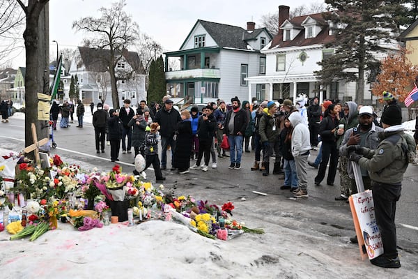 People gather around a makeshift memorial honoring the victim of a fatal shooting involving federal law enforcement agents, near the site of the shooting, Thursday, Jan. 8, 2026, in Minneapolis. (Tom Baker/AP)