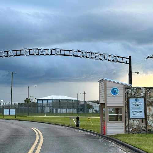 FILE - Clouds hover over the entrance of the Florida State Prison in Starke, Fla., Aug. 3, 2023. (AP Photo/Curt Anderson, file)