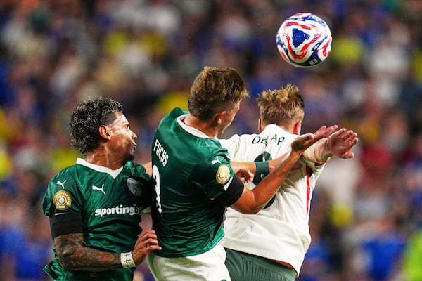 Chelsea's Liam Delap heads the ball with Palmeiras' Richard Rios and Palmeiras' Bruno Fuchs during the Club World Cup quarterfinal soccer match between Palmeiras and Chelsea in Philadelphia, Friday, July 4, 2025. (AP Photo/Derik Hamilton)