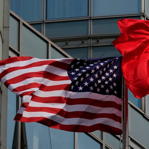 The United States and Chinese flags are flown outside a hotel expected to be used for U.S. President Donald Trump's visit to Beijing Wednesday, May 13, 2026. (AP Photo/Ng Han Guan)