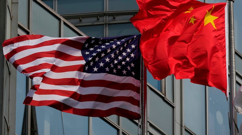 The United States and Chinese flags are flown outside a hotel expected to be used for U.S. President Donald Trump's visit to Beijing Wednesday, May 13, 2026. (AP Photo/Ng Han Guan)
