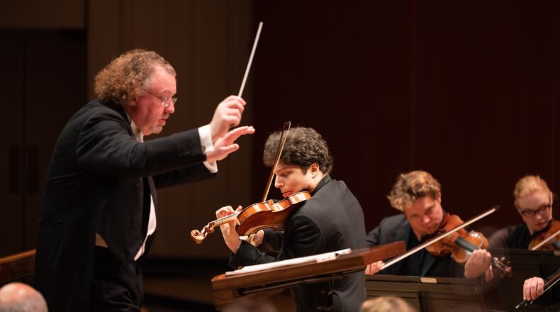 Guest conductor Stéphane Denève and guest soloist Augustin Hadelich performing Thursday night with the Atlanta Symphony Orchestra. (Photos by Rand Lines)