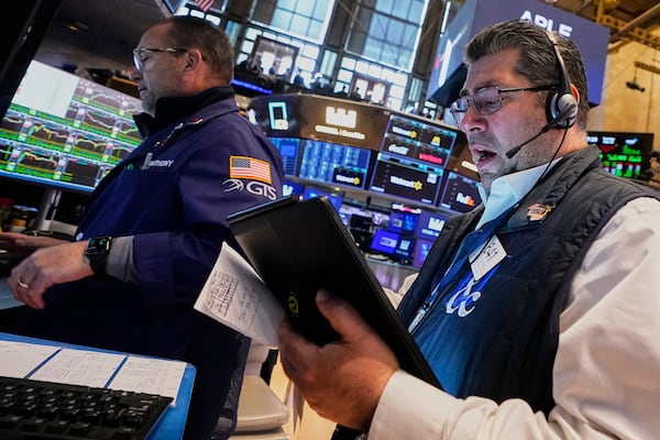 Specialist Anthony Matesic, left, and trader Michael Capolino work on the floor of the New York Stock Exchange, Tuesday, May 20, 2025. (AP Photo/Richard Drew)