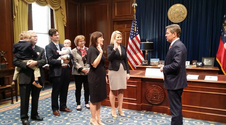 Candice Broce, pictured next to the U.S. flag, raises her right hand to take an oath after Gov. Brian Kemp was sworn in as governor in January 2019. Source: Broce's Facebook page