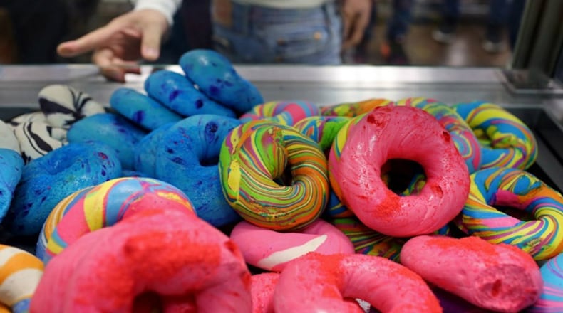 Customers check out rainbow bagels at The Bagel Store in Brooklyn. Rainbow bagels represent a new form of gentrification. MUST CREDIT: Photo for The Washington Post by Yana Paskova.