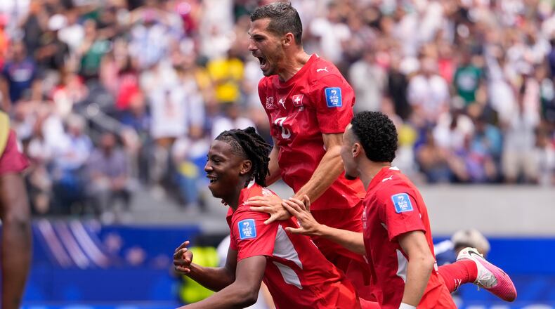Switzerland's Johan Manzambi, left, celebrates with teammates after scoring the opening goal against Bosnia during the World Cup Group B soccer match in Inglewood, Calif., near Los Angeles, Thursday, June 18, 2026. (AP Photo/Mark J. Terrill)