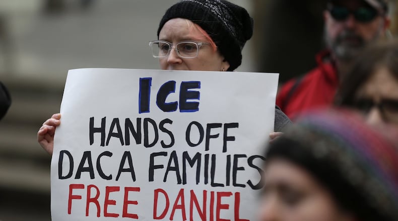 A demonstrator holds a sign that reads "ICE Keep Your Hands Away from DACA Families, Releases Daniel" during a demonstration in front of a federal court on Friday, Feb. 17, 2017, in Seattle. AP photo/Ted S. Warren