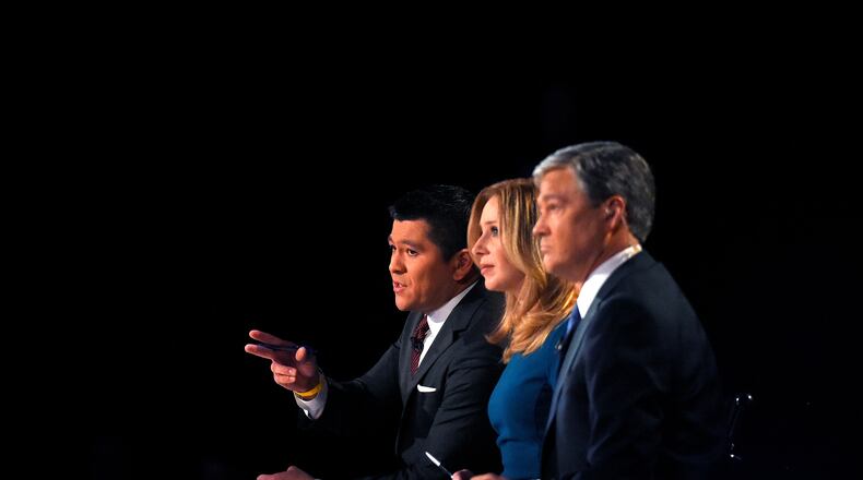 Debate moderators Carl Quintanilla, left, Becky Quick, center, and John Harwood appear during the CNBC Republican presidential debate at the University of Colorado, Wednesday, Oct. 28, 2015, in Boulder, Colo. (AP Photo/Mark J. Terrill)