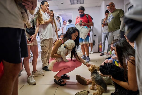 People take shelter in a basement during an alarm of incoming missiles from Iran in Tel Aviv, Israel, Monday, June 23, 2025. (AP Photo/Bernat Armangue)