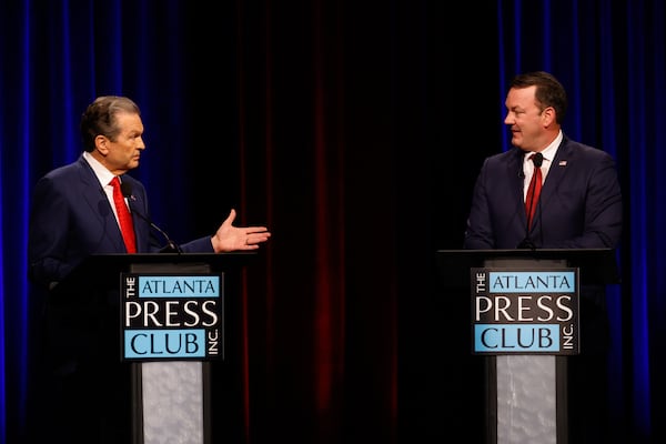 Republican candidates for governor healthcare executive Rick Jackson (left) and Lt. Gov. Burt Jones interact at the Atlanta Press Club Loudermilk-Young governor debate last week. (Arvin Temkar/AJC)