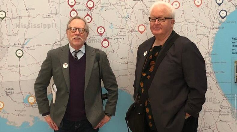 Guy Mendes (left) and Roger Manley stand in front of a map at the High Museum of Art showing all the locations they visited during a series of road trips in the 1980s and early 1990s to see what they called “wonder” — i.e. folk art and folk artists in the Southeast. CONTRIBUTED: KATHERINE JENTLESON