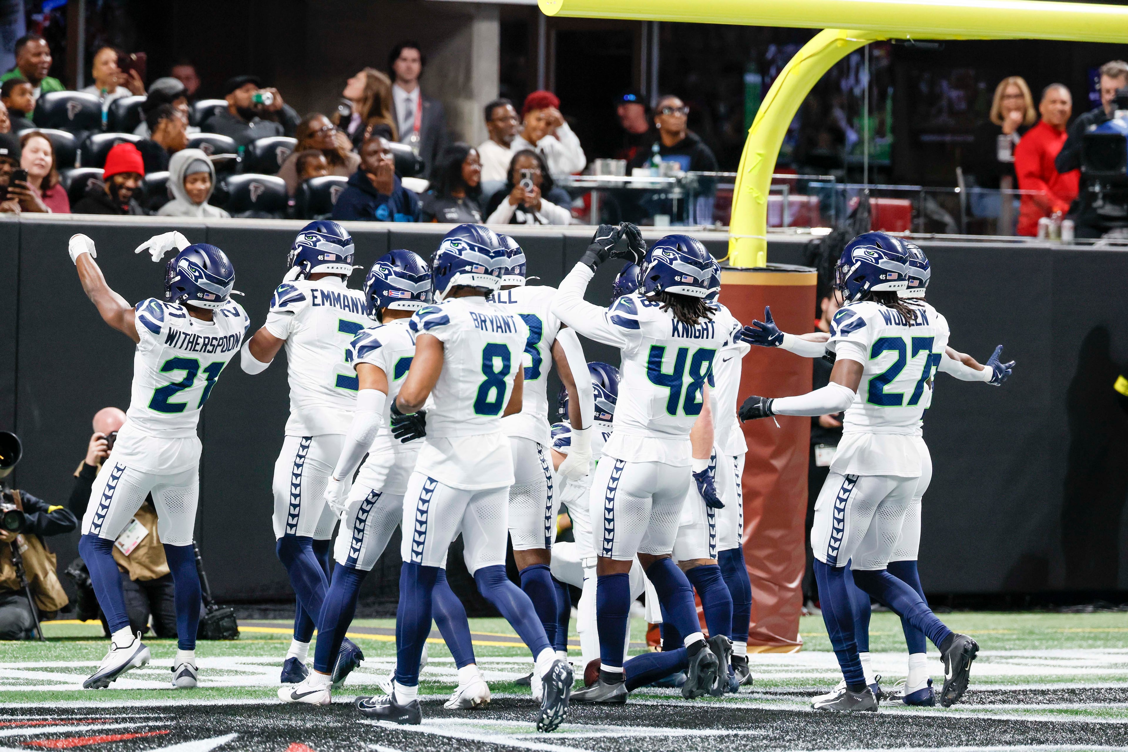 Seattle Seahawks players celebrate after an interception during the second half of an NFL game against the Atlanta Falcons at Mercedes-Benz Stadium in Atlanta on Sunday, Dec. 7, 2025.
(Miguel Martinez/ AJC)