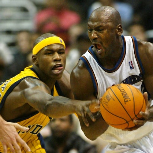 FILE - Washington Wizards' Michael Jordan gets control of the ball with pressure from Indiana Pacers' Al Harrington in the fourth quarter of play, Jan. 4, 2003, in Washington. (AP PHoto/Lawrence Jackson, File)