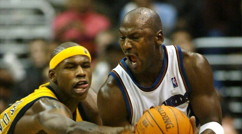 FILE - Washington Wizards' Michael Jordan gets control of the ball with pressure from Indiana Pacers' Al Harrington in the fourth quarter of play, Jan. 4, 2003, in Washington. (AP PHoto/Lawrence Jackson, File)