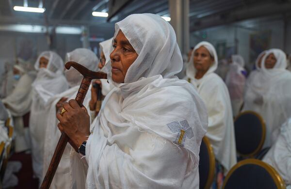 A worshipper holds a prayer staff during a service at Re'ese Adbarat Debre Selam Kidist Mariam Church, an Ethiopian Orthodox Tewahedo church, in Washington, D.C., Saturday, April 5, 2025. (AP Photo/Jessie Wardarski)
