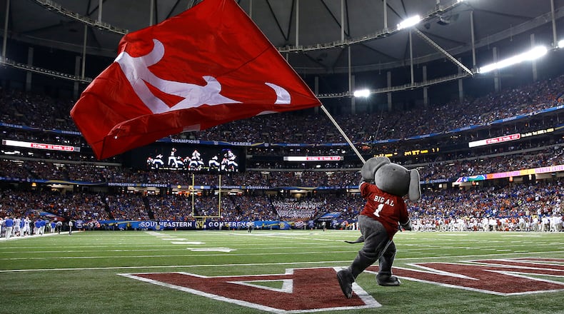 Mascot Big Al of the Alabama Crimson Tide carries a flag across the field during the 2015 SEC Championship game against the Florida Gators at the Georgia Dome in Atlanta.