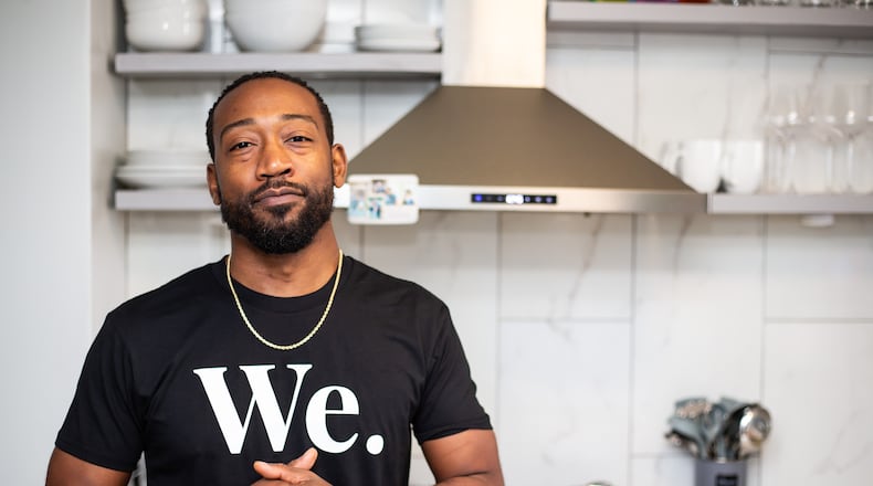 Health concerns pushed Issa Prescott, shown in his home kitchen in Midtown, toward changing his eating habits, and he eventually went vegan. Life Bistro, his restaurant, serves up plant-based versions of American comfort food. (Ryan Fleisher for The Atlanta Journal-Constitution)