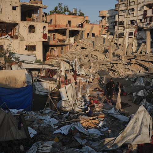 Palestinians salvage their belongings from the rubble of a building and tents destroyed in an Israeli airstrike in Gaza City, Thursday, July 30, 2026. (AP Photo/Jehad Alshrafi)