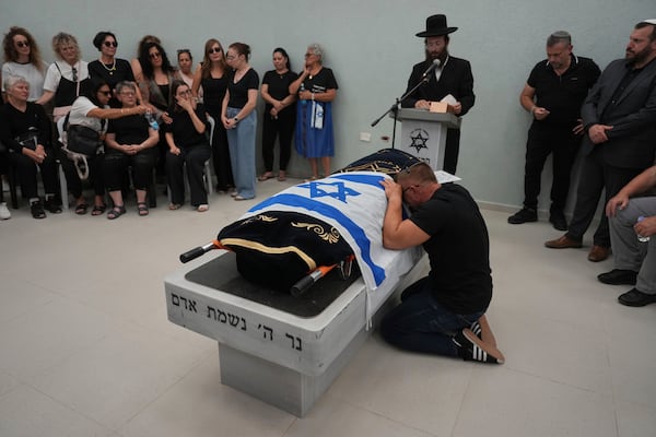 Nikolay Boguslavsky mourns over the body of his daughter, Noa Boguslavsky, 18, who was killed in an Iranian missile strike on a residential building yesterday, a day after the announcement of a ceasefire between Israel and Iran, during her funeral at the cemetery in Arad, Israel, Wednesday, June 25, 2025. (AP Photo/Ariel Schalit)