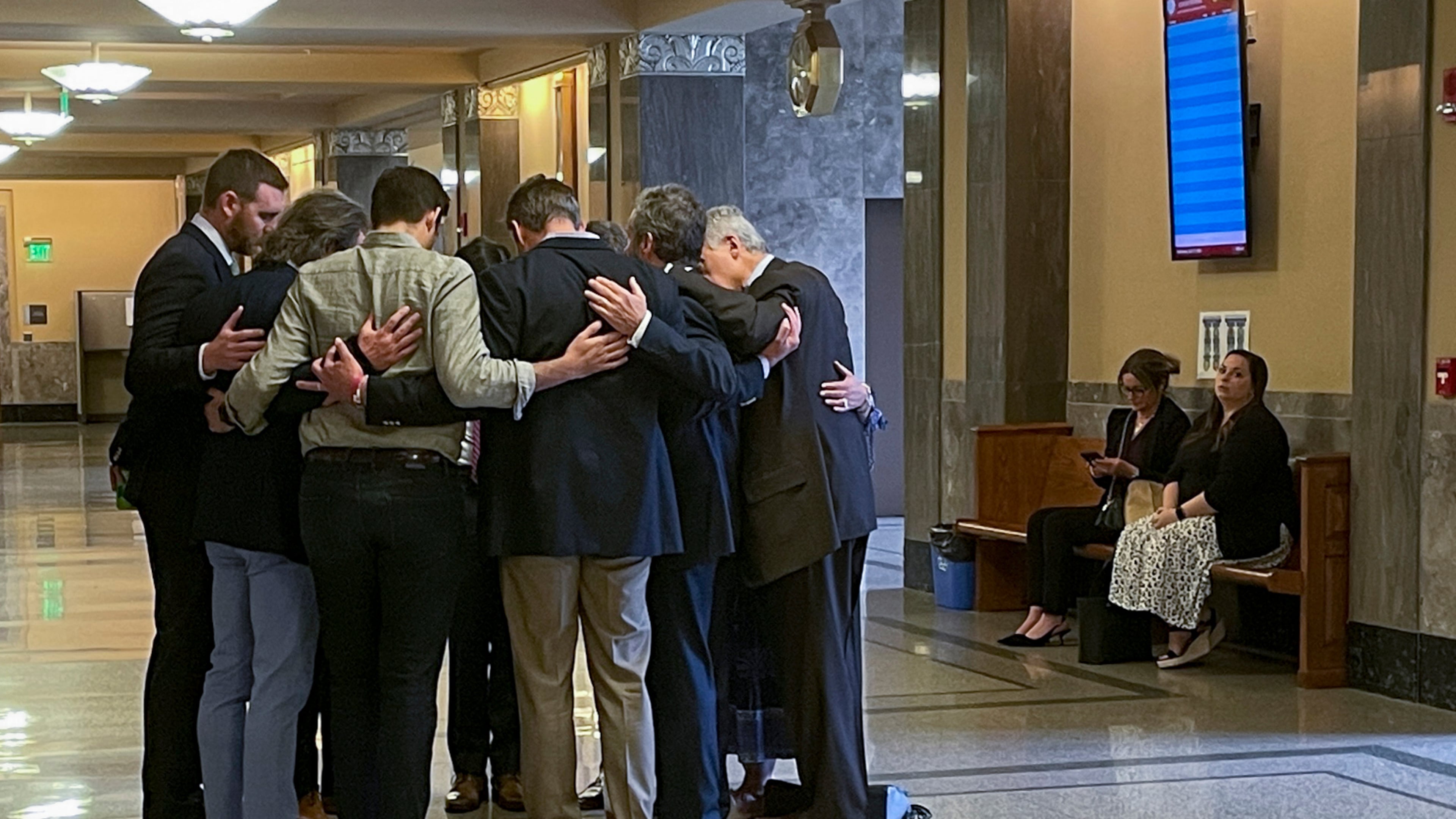 FILE - Covenant School parents and their attorneys huddle in prayer outside a courtroom before a hearing to decide whether documents and journals of a Nashville school shooter can be released to the public April 17, 2024, in Nashville, Tenn. (AP Photo/Travis Loller, File)