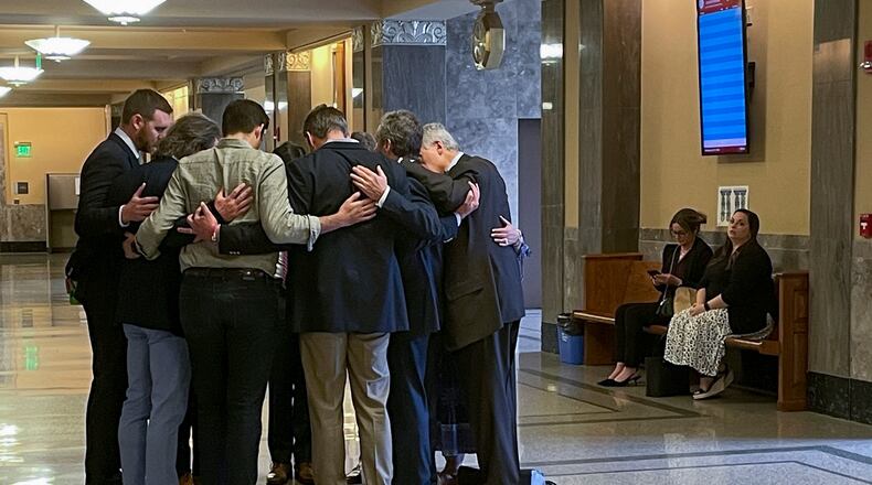 FILE - Covenant School parents and their attorneys huddle in prayer outside a courtroom before a hearing to decide whether documents and journals of a Nashville school shooter can be released to the public April 17, 2024, in Nashville, Tenn. (AP Photo/Travis Loller, File)