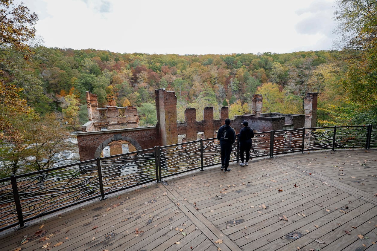 Park visitors take in the view overlooking the old paper mill by Sweetwater Creek State Park on Thursday, October 30, 2025. Georgia’s Board of Natural Resources is expected to double the entrance fee at state parks.
(Miguel Martinez/ AJC)
