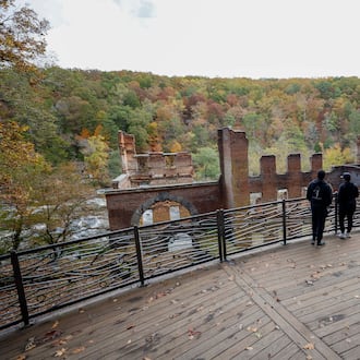 Park visitors take in the view overlooking the old paper mill by Sweetwater Creek State Park on Thursday, October 30, 2025. Georgia’s Board of Natural Resources is expected to double the entrance fee at state parks.
(Miguel Martinez/ AJC)
