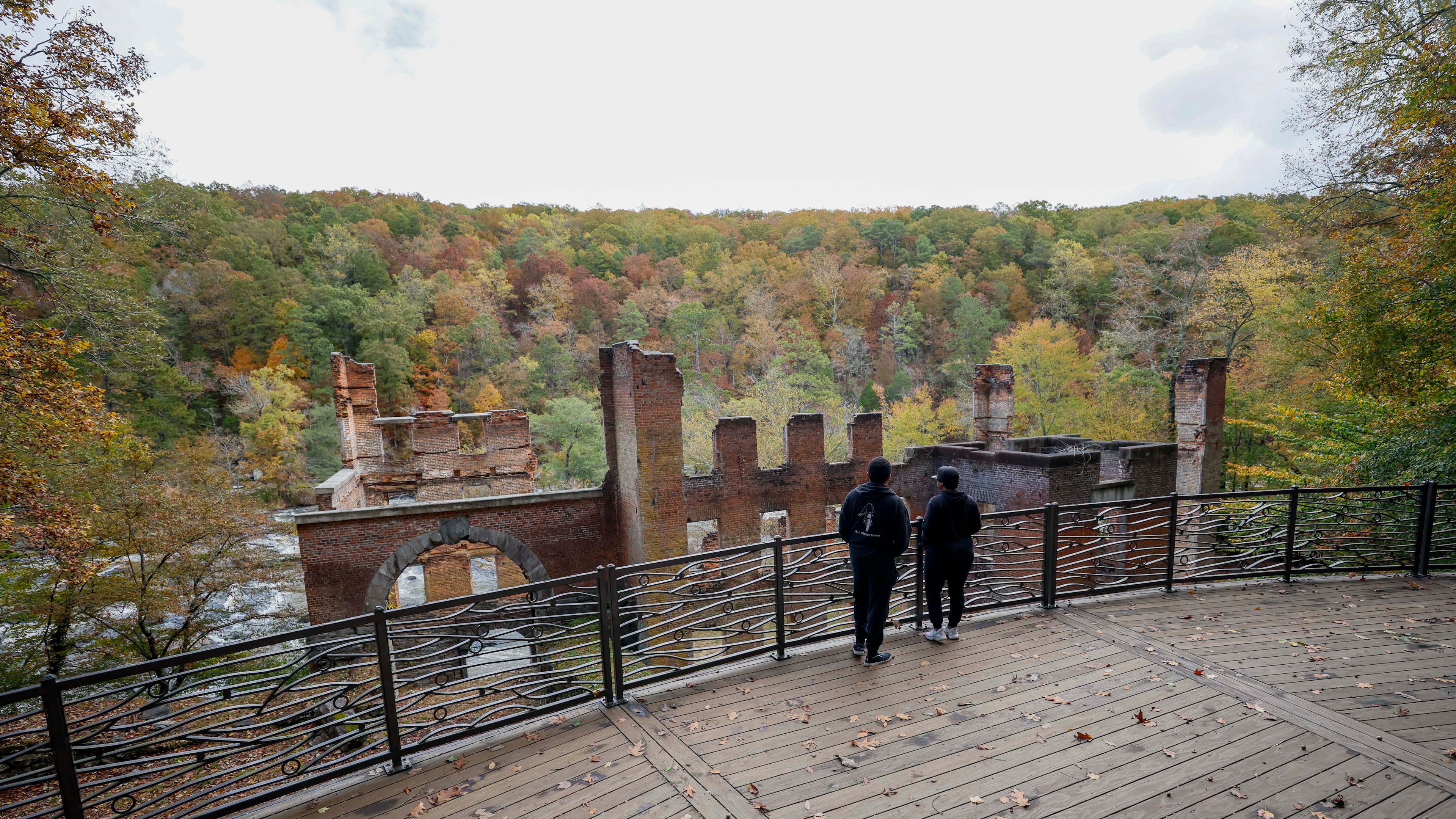 Park visitors take in the view overlooking the old paper mill by Sweetwater Creek State Park on Thursday, October 30, 2025. Georgia’s Board of Natural Resources is expected to double the entrance fee at state parks.
(Miguel Martinez/ AJC)